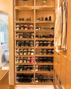 Built in shoe wall after unpacking, with every pair lined up on lit shelves, San Diego