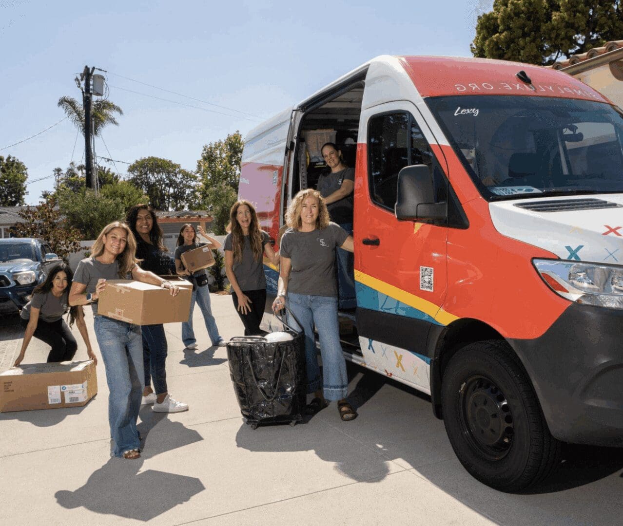 People unloading boxes from a delivery van.