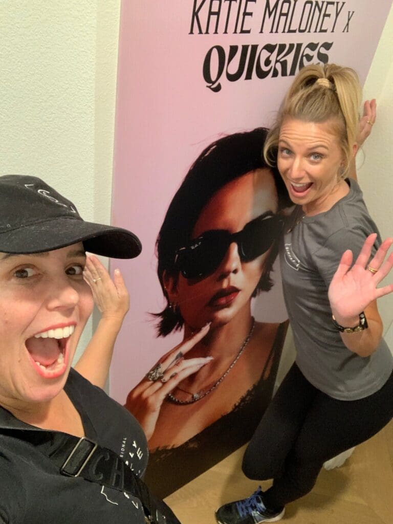 Two Simply Luxe organizers posing next to a life-size Katie Maloney Quickies cutout