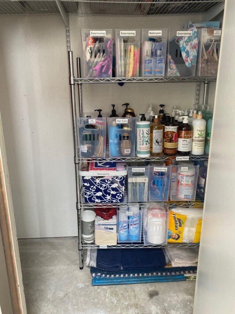 Metal wire shelving in a storage closet with cleaning and household supplies sorted into labeled bins, Orange County