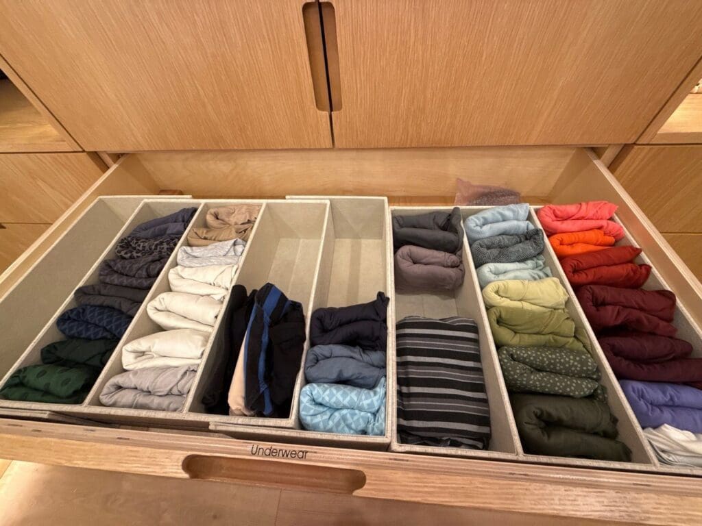 Closet drawer after organizing, with clothes file folded upright in color blocked sections, San Diego