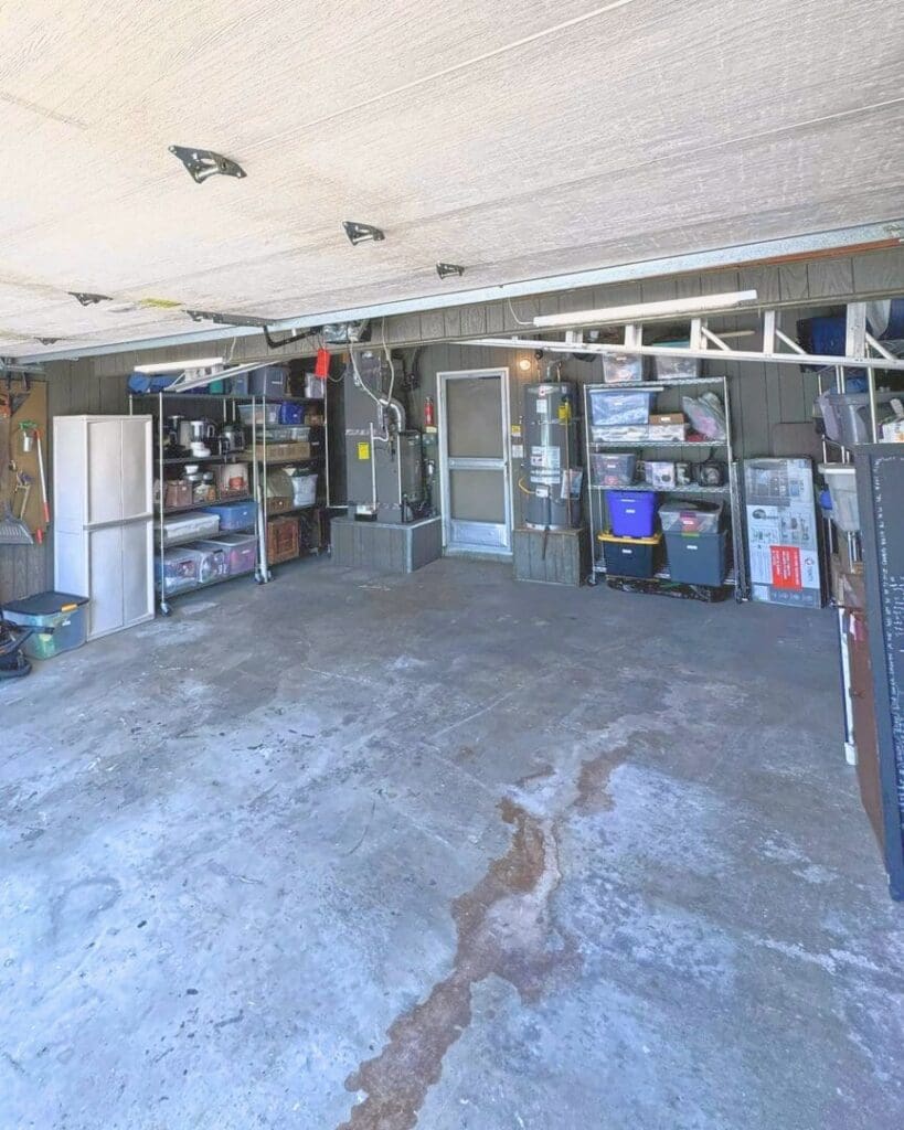 Same two car garage after Simply Luxe organizing, with bins on wire shelving along the back wall, a storage cabinet and a wide open floor, Fountain Valley
