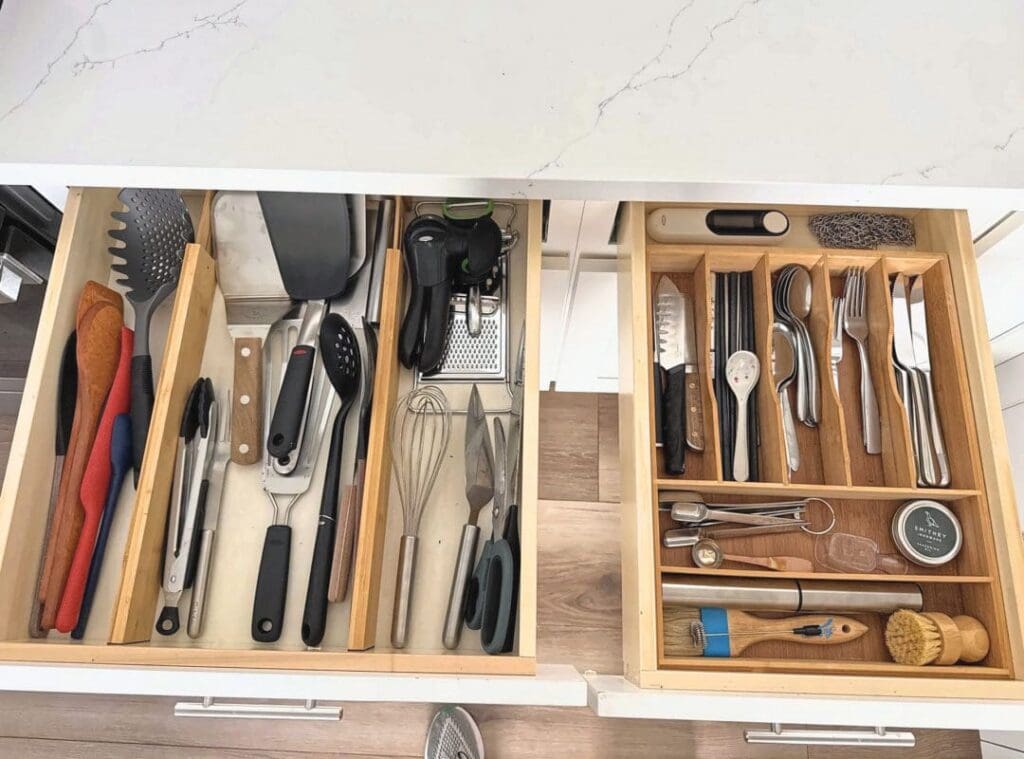 Organized kitchen utensil drawers with bamboo dividers after Simply Luxe reset