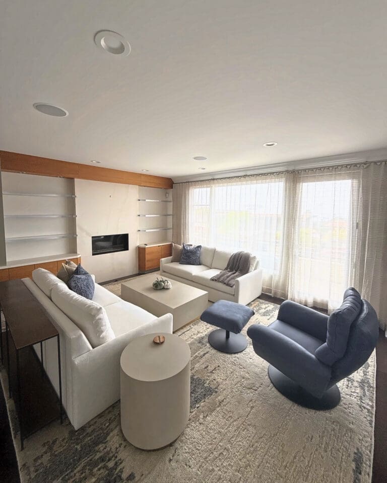 Same vacation rental living room after Simply Luxe setup, sofas, swivel chairs and decor in place, San Diego