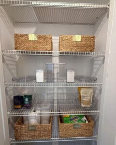 Vacation rental pantry being stocked with baskets and staples, San Diego