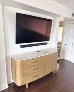 Vacation rental bedroom with a TV and soundbar mounted above a new dresser, San Diego