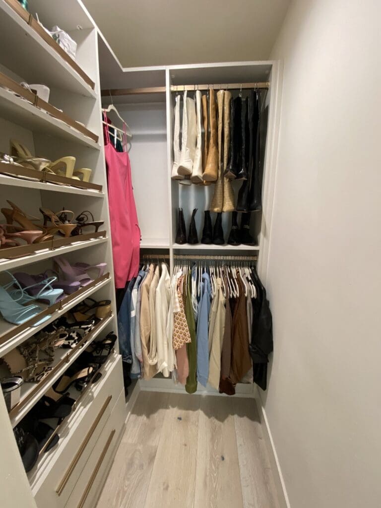 Celebrity closet in La Jolla with shoes on shelves and clothes hung by color, organized by Simply Luxe